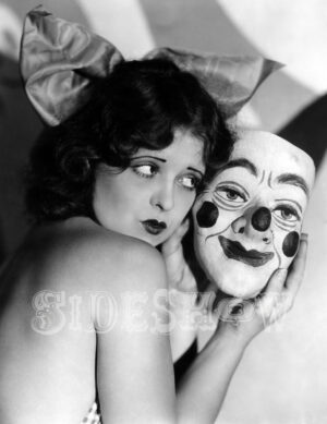 floppy eared woman holding a clown mask